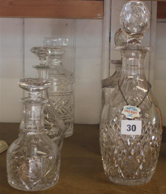 5 glass decanters and a silver enamel label